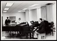 Photograph of Charles Stevens and Everett Pittman playing pianos